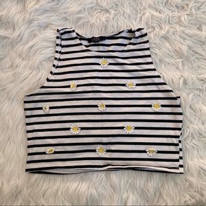 Sleeveless crop top with daisy appliqués.